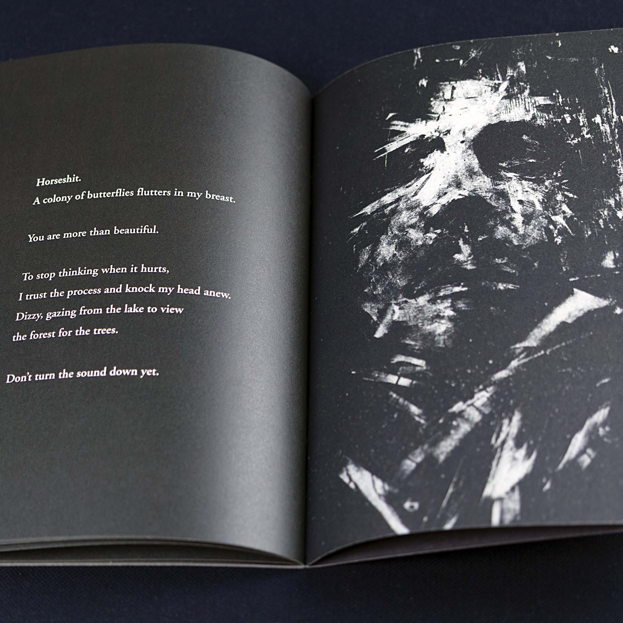 Livret d'art vertical "I'm a Special Rabbit" à couverture noire et blanche texturée, posé debout à côté de deux crayons de bois noirs sur une surface sombre.